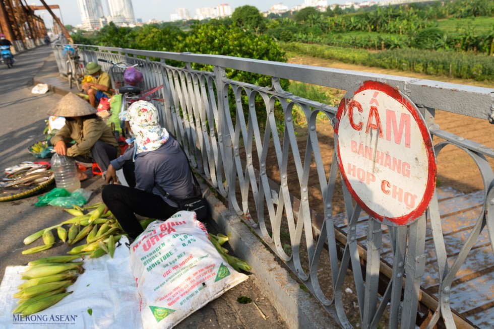 Ngoài ra việc buôn bán, họp chợ trên thành cầu vẫn diễn ra mặc cho biển cấm ngay cạnh.