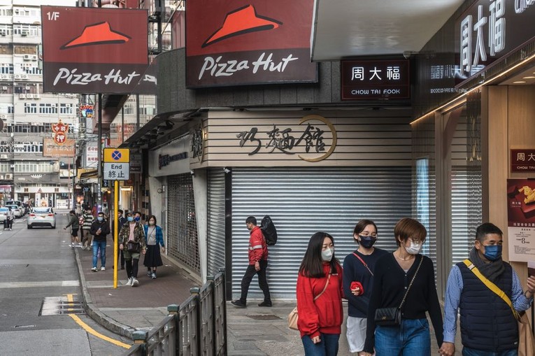 Người d&acirc;n đi bộ tại quận Tsim Sha Tsui, Hong Kong, Trung Quốc. Ảnh: Bloomberg