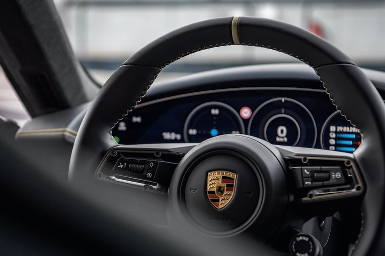 Buồng l&aacute;i c&oacute; c&aacute;c chi tiết ốp gỗ Paldao được thể hiện tr&ecirc;n lỗ th&ocirc;ng gi&oacute;, gi&aacute; để cốc v&agrave; cần chọn hộp số. Người l&aacute;i sẽ cầm tr&ecirc;n tay v&ocirc; lăng thể thao đa chức năng GT c&oacute; c&aacute;c đường chỉ kh&acirc;u v&agrave; vạch 12 giờ m&agrave;u Island Green.