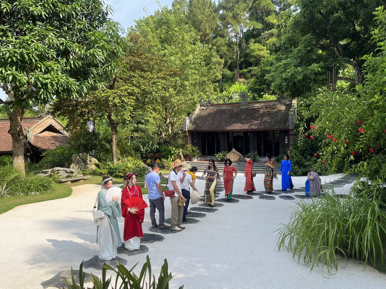 Du kh&aacute;ch chụp ảnh tr&ecirc;n nền sỏi trắng.