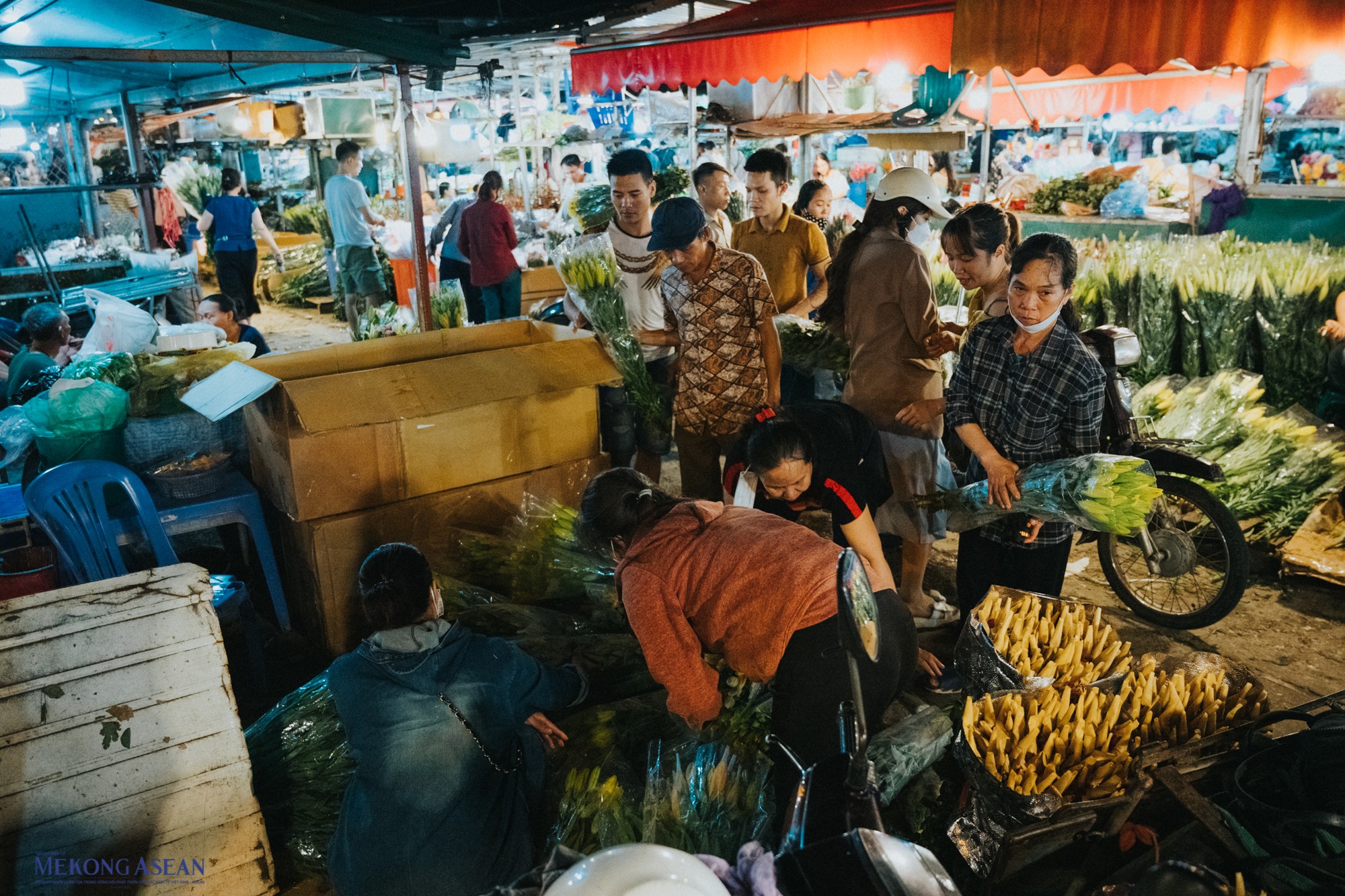 Những tiểu thương v&agrave; chủ h&agrave;ng hoa hối hả chọn lựa hoa.